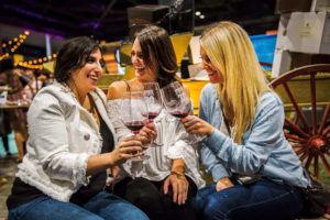 Three ladies find a quiet place to sip wine at Taste Washington.